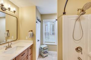 a bathroom with a sink and a shower at 'Phoenix Nest' South Haven Condo: River View! in South Haven +26 photos