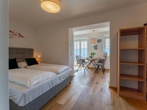 a bedroom with a bed and a dining room with a table at Lärchenhof Top 01 in Mauterndorf +48 photos