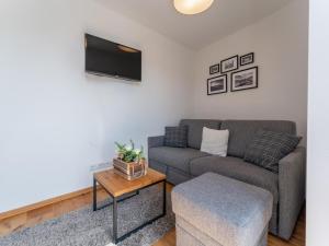 a living room with a couch and a table at Lärchenhof Top 01 in Mauterndorf