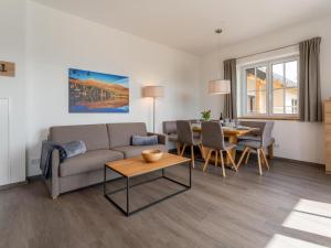 a living room with a couch and a table at Lärchenhof Top 101 in Mauterndorf