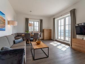 a living room with a couch and a table at Lärchenhof Top 101 in Mauterndorf