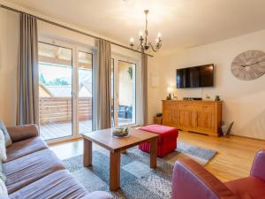 a living room with a couch and a table at Lungau Residence in Tamsweg