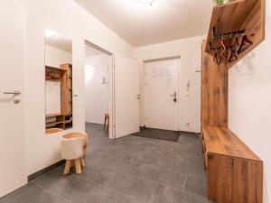 a hallway with a stairwell and a room with a bench at Lungau Residence in Tamsweg +33 photos