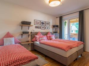 a bedroom with two beds and a window at Lungau Residence in Tamsweg