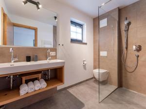 a bathroom with a shower and a sink and a toilet at Wagrainer TauernLodge 42C in Wagrain