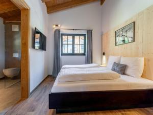 a bedroom with a large bed and a window at Wagrainer TauernLodge 42C in Wagrain
