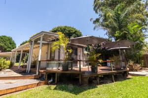 a house with a table and an umbrella at The Lotus Cottage Maleny in Witta