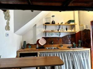 a kitchen with a sink and a wooden counter at Casa Ametista in Lençóis