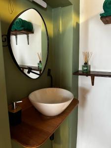 a bathroom with a large bowl sink and a mirror at Casa Ametista in Lençóis +11 photos