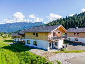 a row of houses with mountains in the background at Sauna Chalet 9B in Obermöschach