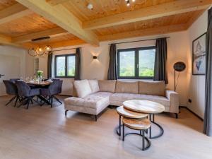 a living room with a couch and a table at Sauna Chalet 9B in Obermöschach