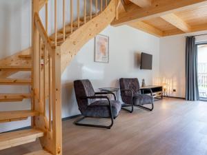 a room with a staircase and two chairs and a table at Obermöschach 7A in Obermöschach