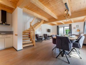 a dining room and living room with a wooden ceiling at Obermöschach 7A in Obermöschach