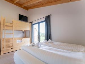 a bedroom with two beds and a large window at Obermöschach 7A in Obermöschach