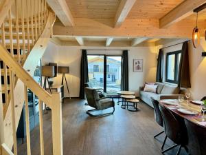 a living room with wooden ceilings and a staircase at Obermöschach 6A in Obermöschach