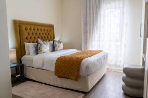 a bedroom with a large bed and a window at Ngalufuno-wlove in Johannesburg
