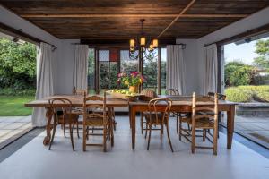 a dining room with a wooden table and chairs at Stone Street Cottage by Sothebys Luxury Rental Homes in Wanaka