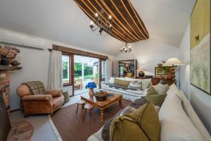 a living room with a couch and a table at Stone Street Cottage by Sothebys Luxury Rental Homes in Wanaka