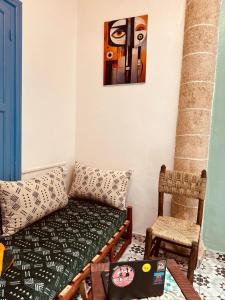 a living room with a couch and a chair at essaouira van hostel in Essaouira