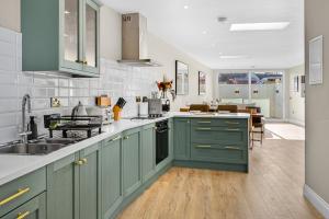 a kitchen with green cabinets and a sink at Martin Savage in Sligo