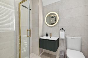 a bathroom with a toilet and a sink and a mirror at Martin Savage in Sligo +57 photos