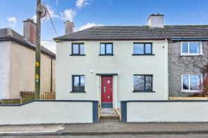 a white house with a red door at Martin Savage in Sligo