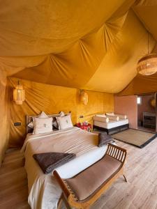 a bedroom with a large bed in a tent at Le Pacha Luxury Desert Camp - Mhamid Sahara Activities in Mhamid