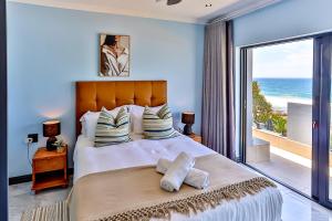 a bedroom with a bed with a view of the ocean at Villa Belle Mere Boutique Hotel in Sheffield Beach +87 photos