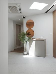 a hallway with a table and a potted plant at The Road Mini Hotel in Seoul