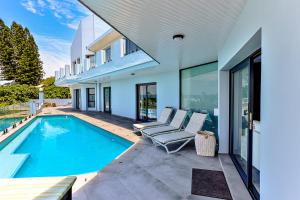 a swimming pool in the backyard of a house at Villa Belle Mere Boutique Hotel in Sheffield Beach