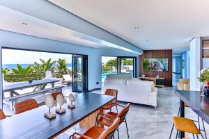 a living room with a view of the ocean at Villa Belle Mere Boutique Hotel in Sheffield Beach
