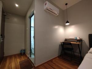 a small room with a table and a air conditioner on the wall at Mirani Hotel Ampang Near Melawati Mall in Kuala Lumpur