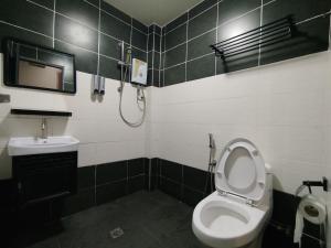 a bathroom with a toilet and a sink at Mirani Hotel Ampang Near Melawati Mall in Kuala Lumpur