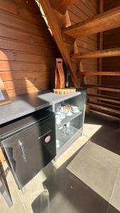 a kitchen with a glass cabinet in a room at Cabana de Vidro - Canelinha in Canelinha +14 photos