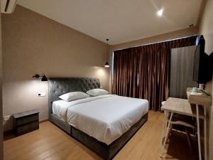 a bedroom with a large bed and a large window at Mirani Hotel Ampang Near Melawati Mall in Kuala Lumpur