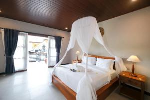 a bedroom with a bed with a mosquito net at Arsyana Villa in Sidemen +12 photos