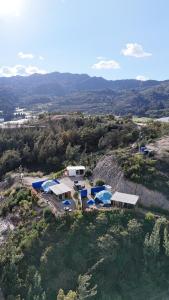 an aerial view of a house on a hill at Juncos Glamping in Fúquene