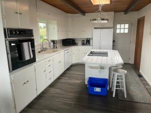 a kitchen with white cabinets and a counter top at A-town MSM Charmer in Anacortes