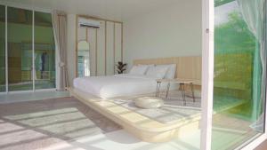 a bedroom with a bed and a table in it at Japanese house PhuSaimorkVilla in Ban Kai Noi +13 photos