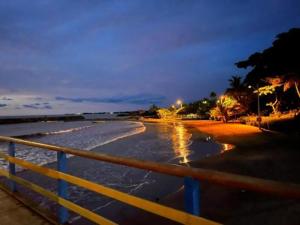 a view of a beach at night with a fence at Hotel ANY in Los Córdobas