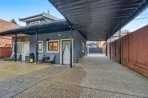 a patio with awning over a building with chairs at Secluded Bachelor Suite in Vancouver