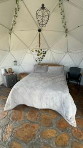 a bedroom with a large bed in a yurt at Juncos Glamping in Fúquene +58 photos