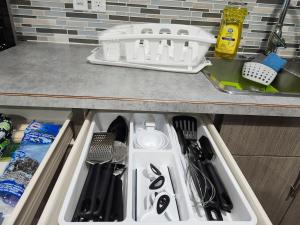 a kitchen drawer filled with utensils on a counter at Stromberg Court in Saskatoon +19 photos