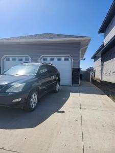 a car parked in front of a garage at Stromberg Court in Saskatoon
