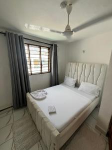 a bedroom with a large bed in a room at Azure Coast retreat in Watamu