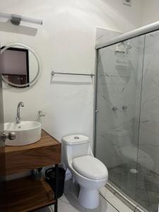 a bathroom with a toilet and a sink and a shower at Valle Stay in Cedro