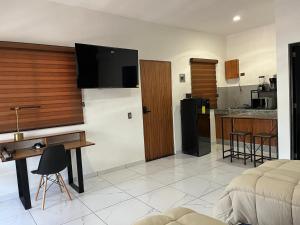 a living room with a couch and a kitchen at Valle Stay in Cedro +4 photos