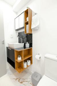 a bathroom with a sink and a toilet at P&G Apto 203-Bagnoregio in Caxias do Sul
