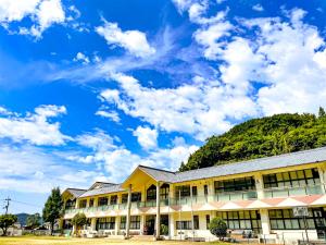 a school building with a blue sky in the background at 楽校うらしり in Uwajima