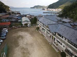 an aerial view of a town with a body of water at 楽校うらしり in Uwajima